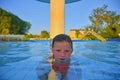 Little girl in swimming pool. Portrait of little cute girl in the swimming pool. Sunny summer day. Summer and happy childhood conc Royalty Free Stock Photo