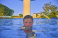 Little girl in swimming pool. Portrait of little cute girl in the swimming pool. Sunny summer day. Summer and happy chilhood conce Royalty Free Stock Photo