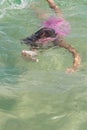 Little girl swimming in the sea under the water in a mask for diving, Royalty Free Stock Photo