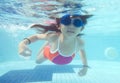 Little girl swimming underwater