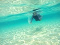 Little girl swimming underwater without equipment. Royalty Free Stock Photo