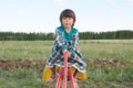 Little girl swing on seesaw at summer, funny face happy child in green dress
