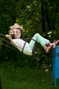 Little girl on a swing in the summer park Royalty Free Stock Photo
