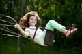 Little girl on a swing in the summer park Royalty Free Stock Photo