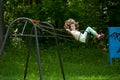 Little girl on a swing in the summer park Royalty Free Stock Photo