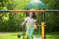 Little girl on a swing in the summer park Royalty Free Stock Photo