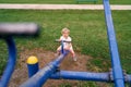 Little girl swinging on a balance swing in the playground Royalty Free Stock Photo