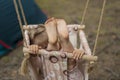 Little girl swinging on a swing. Child`s feet. Baby having fun. Camping life with a child. Royalty Free Stock Photo