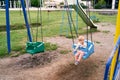 Little girl swinging on a swing in the courtyard of an apartment building Royalty Free Stock Photo