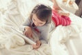 Little girl with tablet computer in bed Royalty Free Stock Photo