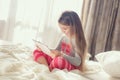 Little girl with tablet computer in bed Royalty Free Stock Photo