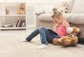 Little girl with tablet sitting on floor at home Royalty Free Stock Photo