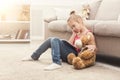 Little girl with tablet sitting on floor at home Royalty Free Stock Photo