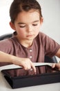 Little girl, tablet and watching in living room for games, online entertainment or research at home. Face of young Royalty Free Stock Photo