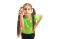 Little girl with tails and bright t-shirt posing in the Studio and shows finger Royalty Free Stock Photo