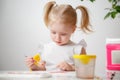 A Little Girl, With Tails On Her Head, Draws Watercolors Sitting At a Table. The Child Likes To Be Creative. Royalty Free Stock Photo