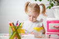 A Little Girl, With Tails On Her Head, Draws Watercolors Sitting At a Table. The Child Likes To Be Creative Royalty Free Stock Photo