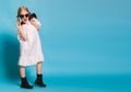 Little girl with tails in stylish clothes on blue background Royalty Free Stock Photo