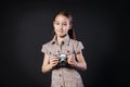 Little girl take photo with vintage camera at black background Royalty Free Stock Photo