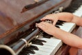 The little girl takes the clarinet lying on the black piano keys Royalty Free Stock Photo