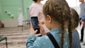 Little girl takes photo of room using smartphone camera