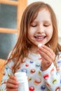 Little girl takes vitamins, takes a tablet from a jar and puts it in her mouth
