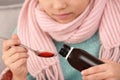 Little girl taking cough syrup Royalty Free Stock Photo