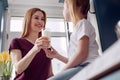 Little girl taking glass of milk from mothers hands Royalty Free Stock Photo