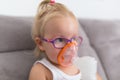 Little girl is taking inhalation therapy Royalty Free Stock Photo