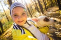 Little girl taking selfie with her dog at autumn park. Child posing with jack russell terrier for a picture on the Royalty Free Stock Photo