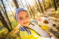 Little girl taking selfie with her dog at autumn park. Child posing with jack russell terrier for a picture on the Royalty Free Stock Photo