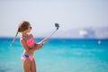 Little girl taking selfie portrait with her smartphone on the beach Royalty Free Stock Photo