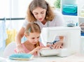 Little girl is taught to sew Royalty Free Stock Photo