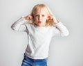 little girl teasing, showing tongue and doing face, on white background,