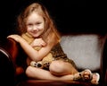 Little girl with a teddy bear on a black background. Royalty Free Stock Photo