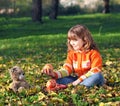 Little girl and teddy bear in park Royalty Free Stock Photo