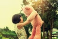 little girl with teddy bear standing and sunset