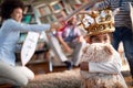 A little girl with teddy posing for a photo while having a fun with her family at home. Family, together, love, playtime Royalty Free Stock Photo