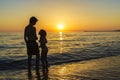 Little girl and teenager bathing on a beach at sunset Royalty Free Stock Photo