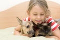 Little girl tenderly embraces pets Royalty Free Stock Photo