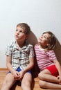 Little girl and thoughtful boy sitting Royalty Free Stock Photo