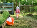 The little girl threw all the games and goes into the open gate on the road Royalty Free Stock Photo