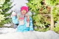 Little girl throw snowball hiding behind snow wall Royalty Free Stock Photo