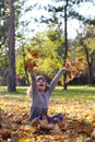 Little girl throws leaves Royalty Free Stock Photo