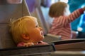 Little girl tired and bored in plane, child afraid of flying