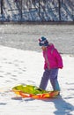 Little girl with toboggan