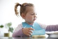 Little girl toddler picking her food, making faces Royalty Free Stock Photo