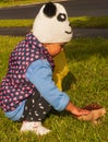 Little girl touches mushroom Royalty Free Stock Photo