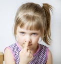 Little girl touching her nose