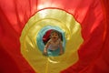 Little girl in a toy tunnel Royalty Free Stock Photo